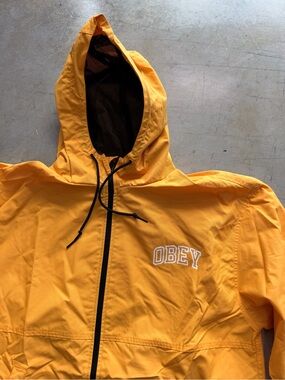 Obey Men’s Bright Yellow Hooded Windbreaker with Black Trim